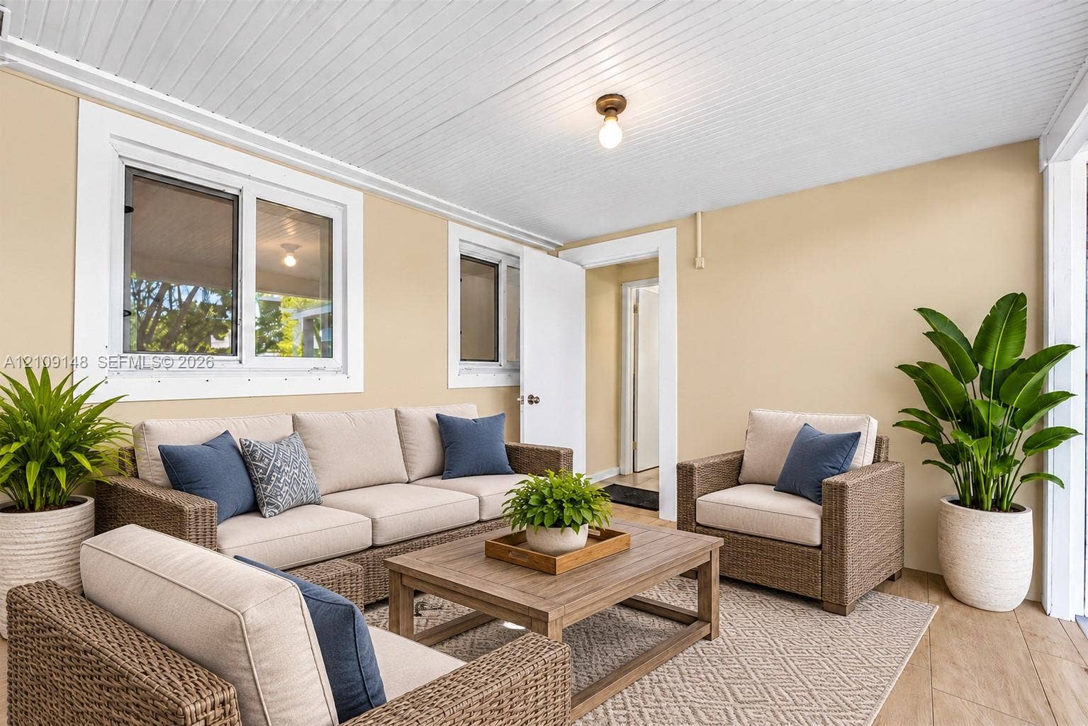 1701 SW 23rd Avenue, Fort Lauderdale, FL 33312 Covered porch featuring wood-finish flooring, beadboard ceiling, and dual-pane windows
