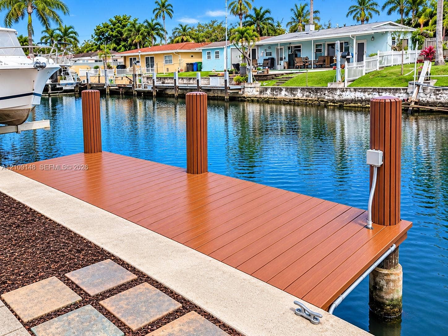 1701 SW 23rd Avenue, Fort Lauderdale, FL 33312 Waterfront dock featuring composite decking, vertical pilings, and a concrete bulkhead