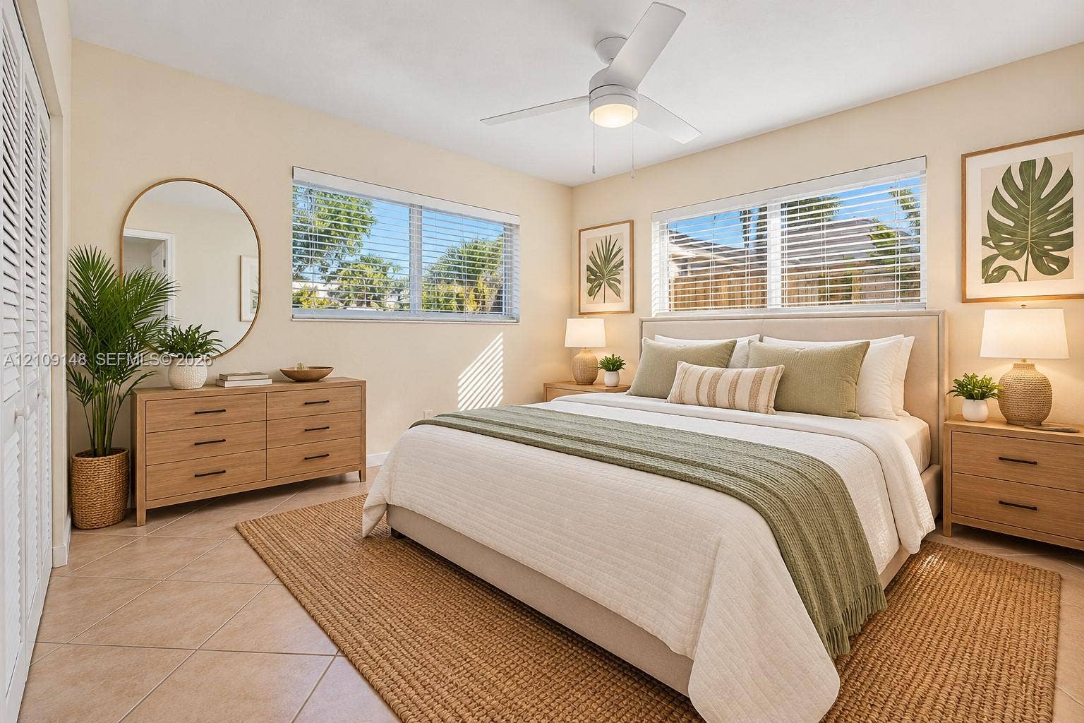 1701 SW 23rd Avenue, Fort Lauderdale, FL 33312 Neutral-toned interior featuring tile flooring, dual-pane windows, louvered closet doors, and a ceiling fan with integrated lighting
