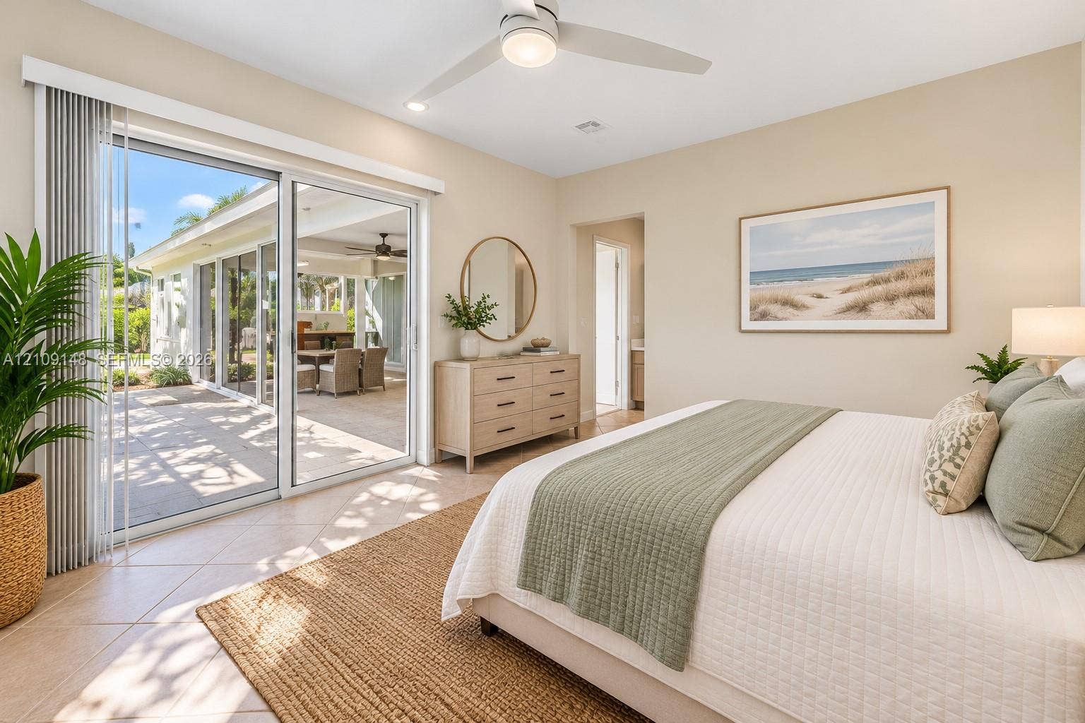 1701 SW 23rd Avenue, Fort Lauderdale, FL 33312 Neutral-toned interior featuring oversized glass sliding doors, tile flooring, and a modern ceiling fan