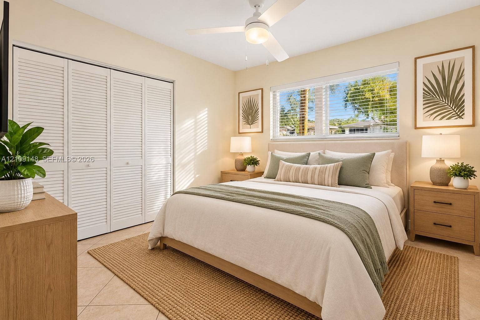1701 SW 23rd Avenue, Fort Lauderdale, FL 33312 Bedroom featuring large windows with horizontal blinds, neutral tile flooring, louvered bi-fold closet doors, and a ceiling fan with integrated lighting