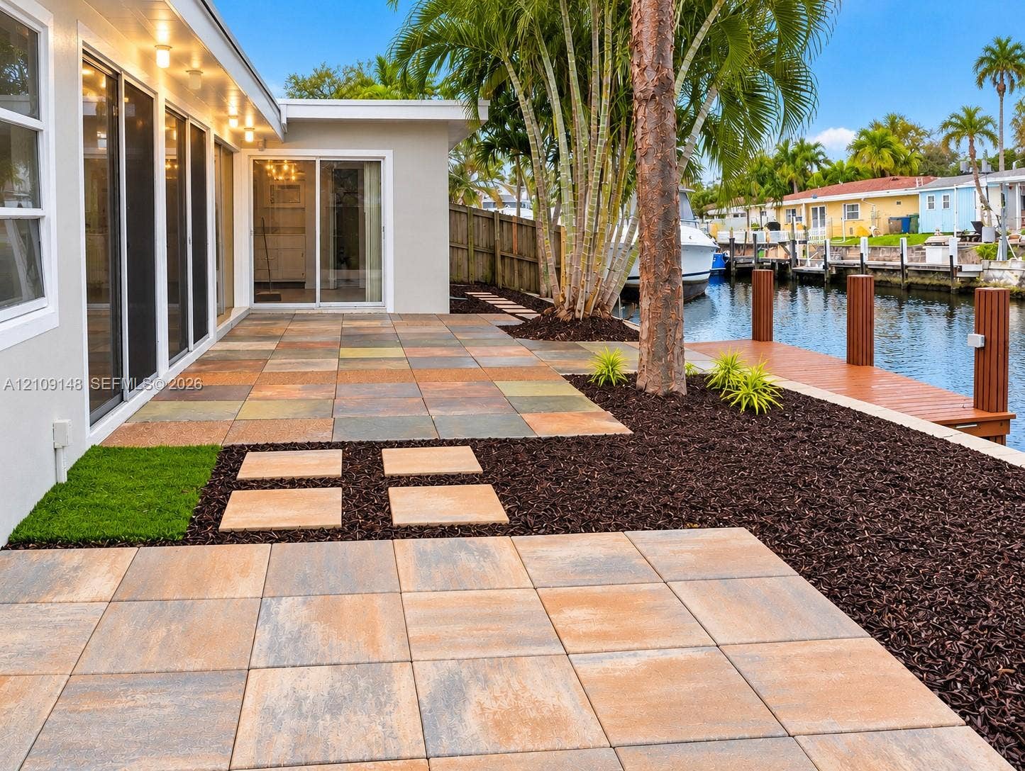 1701 SW 23rd Avenue, Fort Lauderdale, FL 33312 Waterfront patio featuring large-format paver tile flooring, recessed soffit lighting, and a private dock