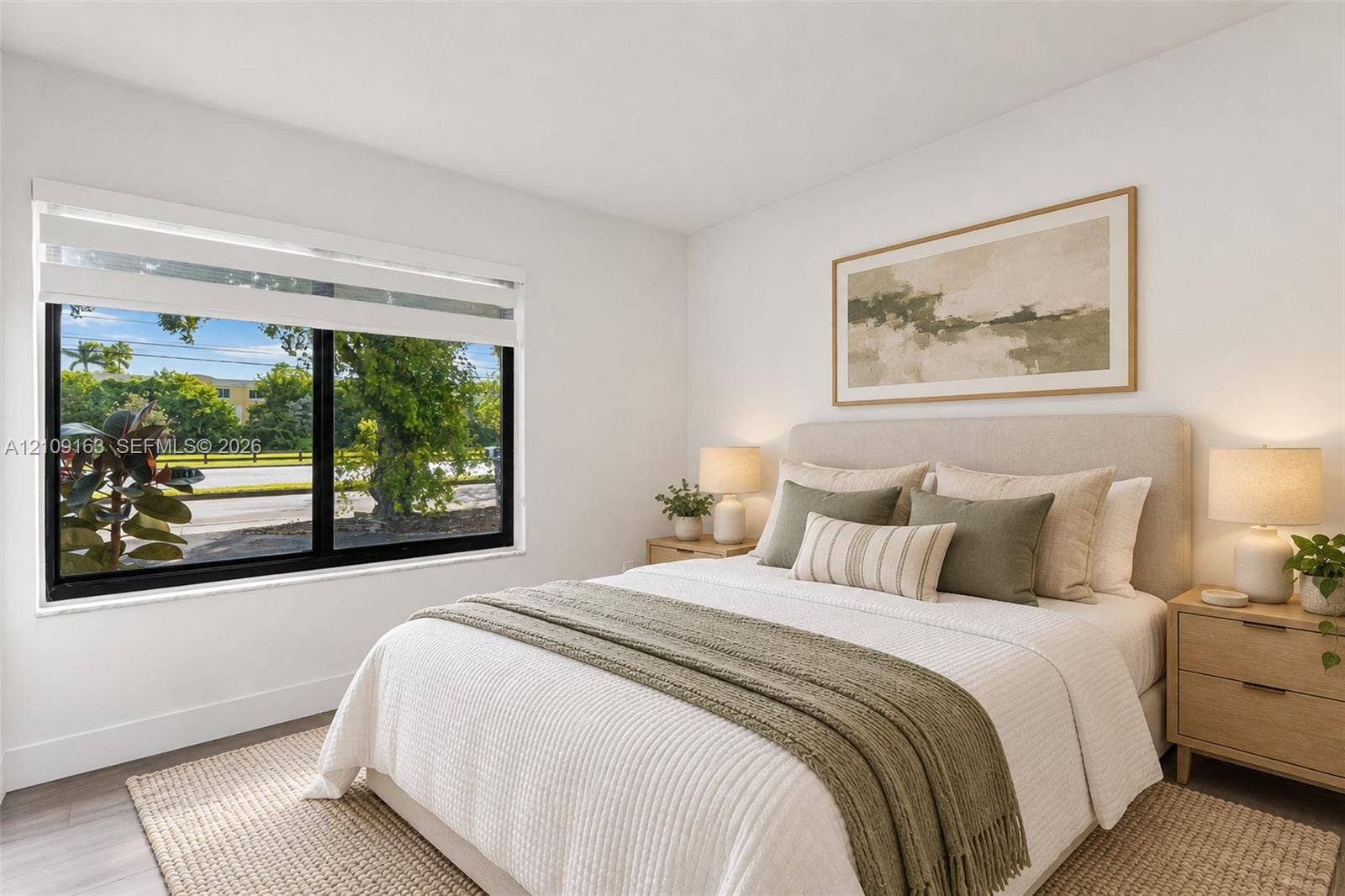 9122 SW 127th Avenue, Miami, FL 33186 Bedroom featuring large-format window with black framing and light-toned wood-finish flooring