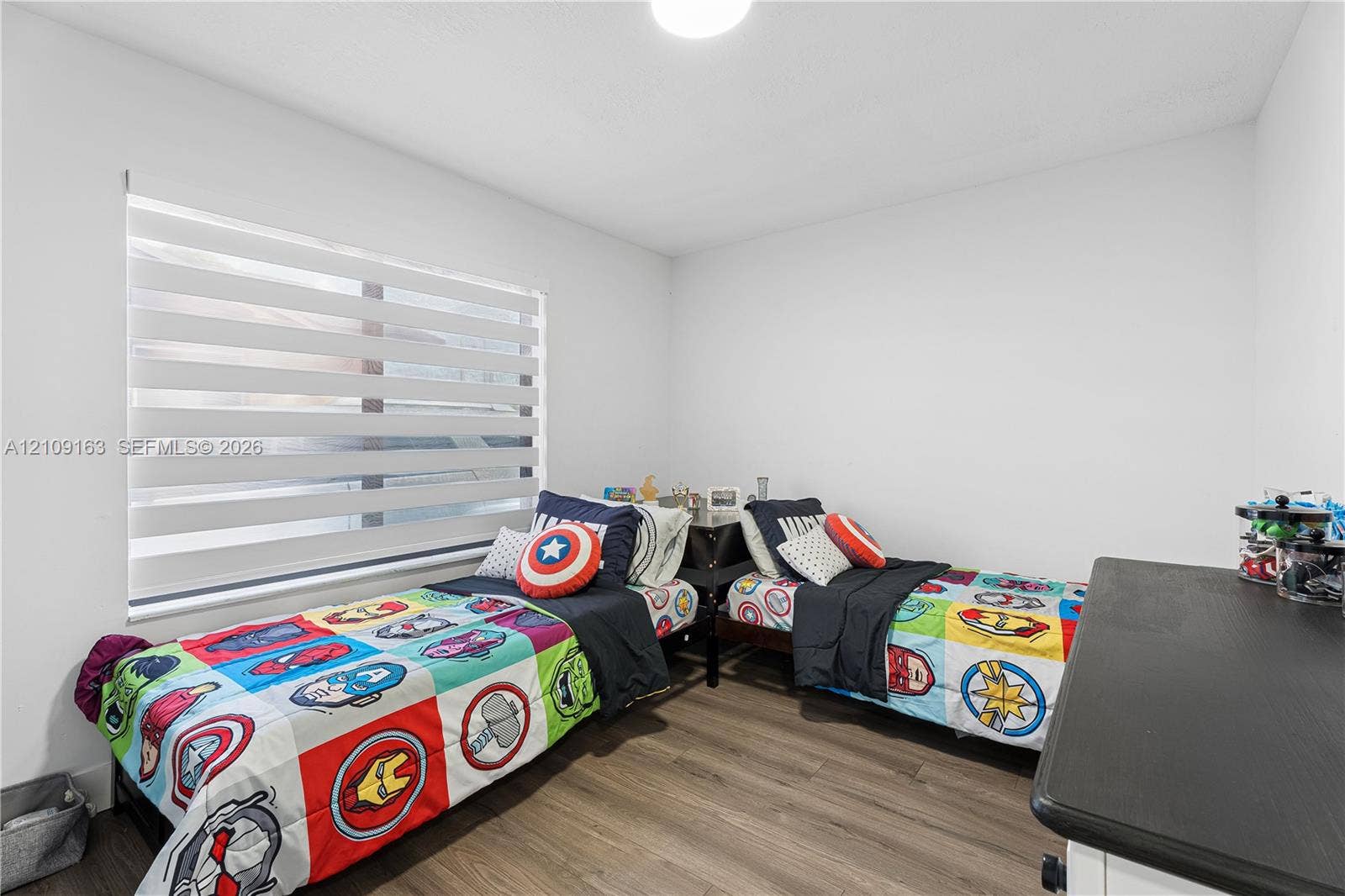 9122 SW 127th Avenue, Miami, FL 33186 Neutral-toned walls, wood-finish flooring, and horizontal dual-layer light-filtering window shades