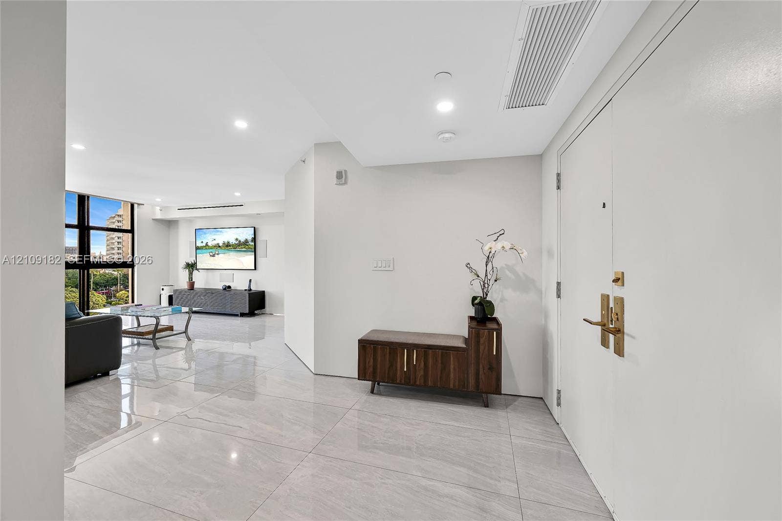 Interior space featuring light-toned tile flooring, smooth ceiling surfaces, recessed lighting, and expansive windows