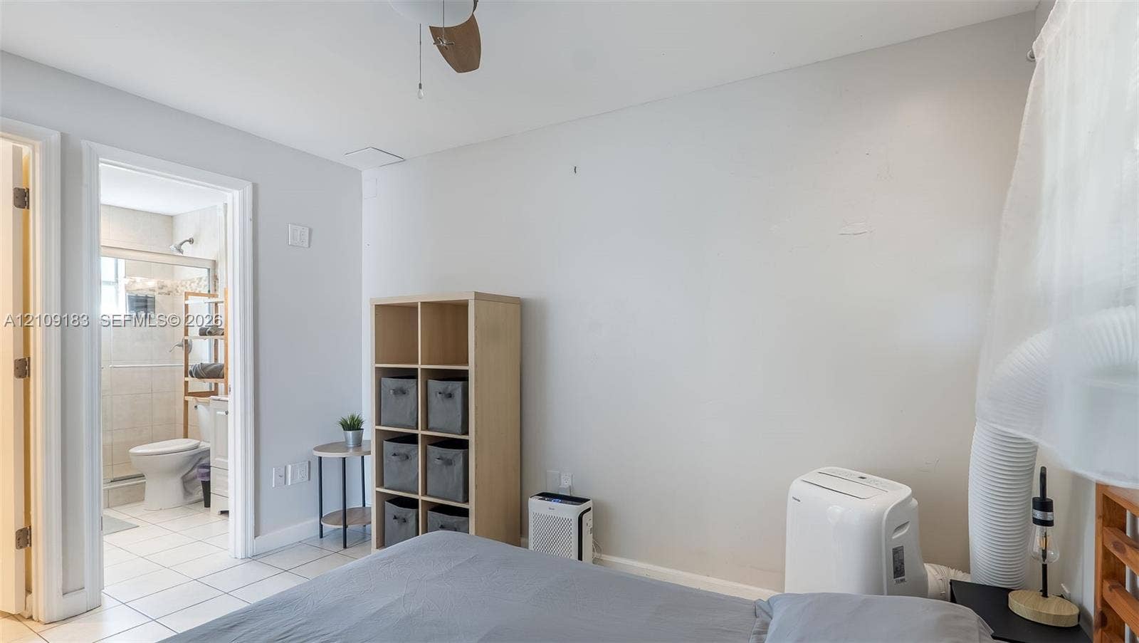 1009 NE 17th Court, Fort Lauderdale, FL 33305 Room featuring a ceiling fan, light-colored neutral wall paint, and ceramic tile flooring throughout the interior space