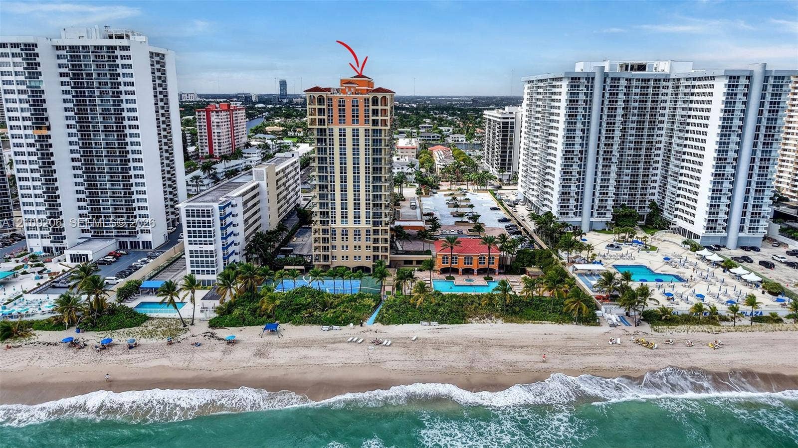 2080 S Ocean Drive, #112, Hallandale Beach, Hallandale Beach, FL 33009 High-rise residential tower featuring a tile roof, private swimming pool, tennis court, and direct beach access