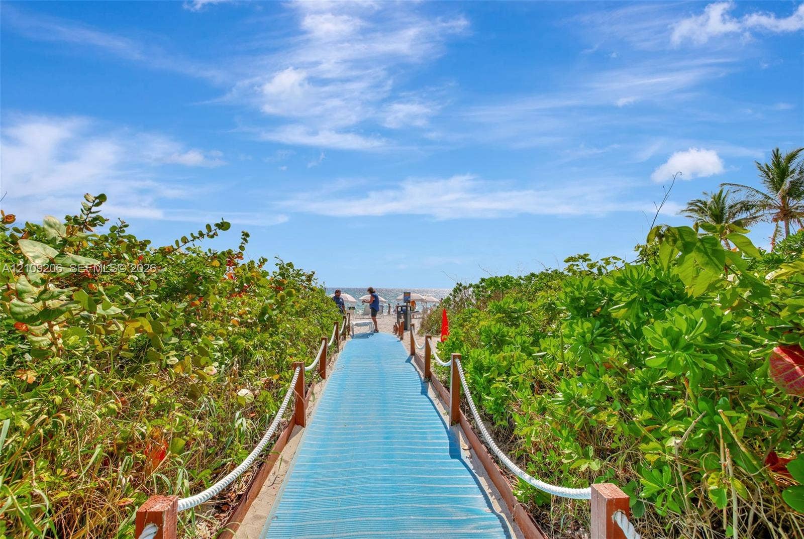 2080 S Ocean Drive, #112, Hallandale Beach, Hallandale Beach, FL 33009 Elevated beach access boardwalk featuring wood posts, rope handrails, and mature coastal vegetation