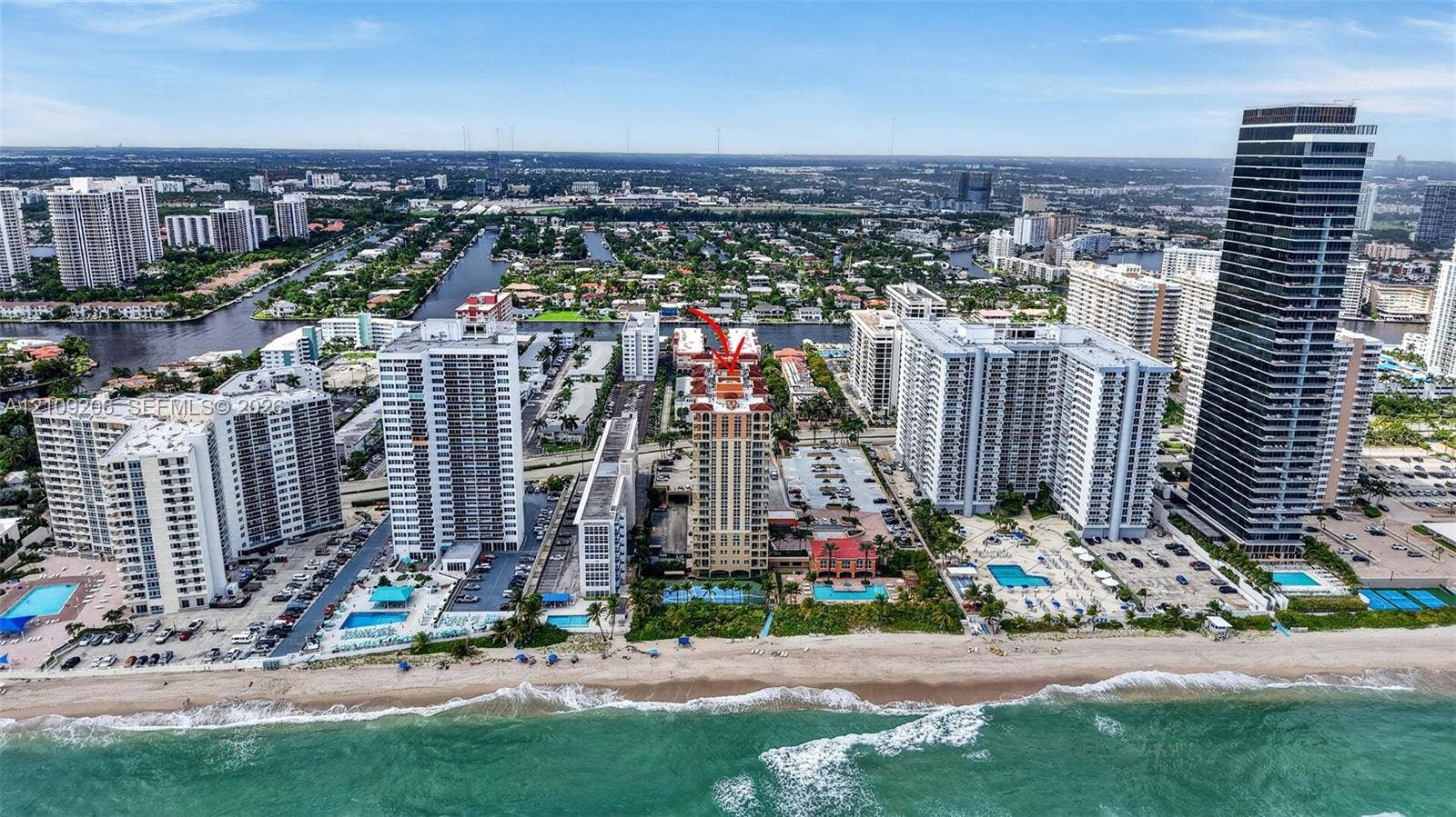 2080 S Ocean Drive, #112, Hallandale Beach, Hallandale Beach, FL 33009 Aerial perspective of coastal high-rise development featuring direct beach access, oceanfront swimming pools, and surface parking areas