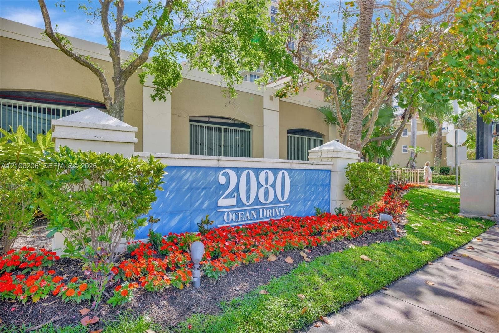 2080 S Ocean Drive, #112, Hallandale Beach, Hallandale Beach, FL 33009 Exterior monument signage featuring raised address lettering, concrete masonry construction, manicured landscaping, and low-voltage landscape lighting