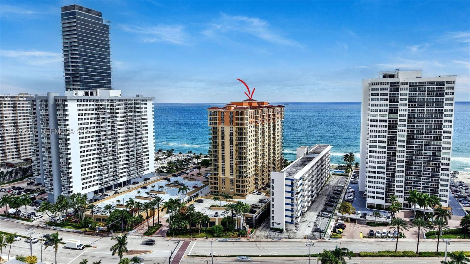 2080 S Ocean Drive, #112, Hallandale Beach, Hallandale Beach, FL 33009 High-rise coastal condominium tower featuring multiple private balconies, a terracotta-style roofline, and direct proximity to the oceanfront