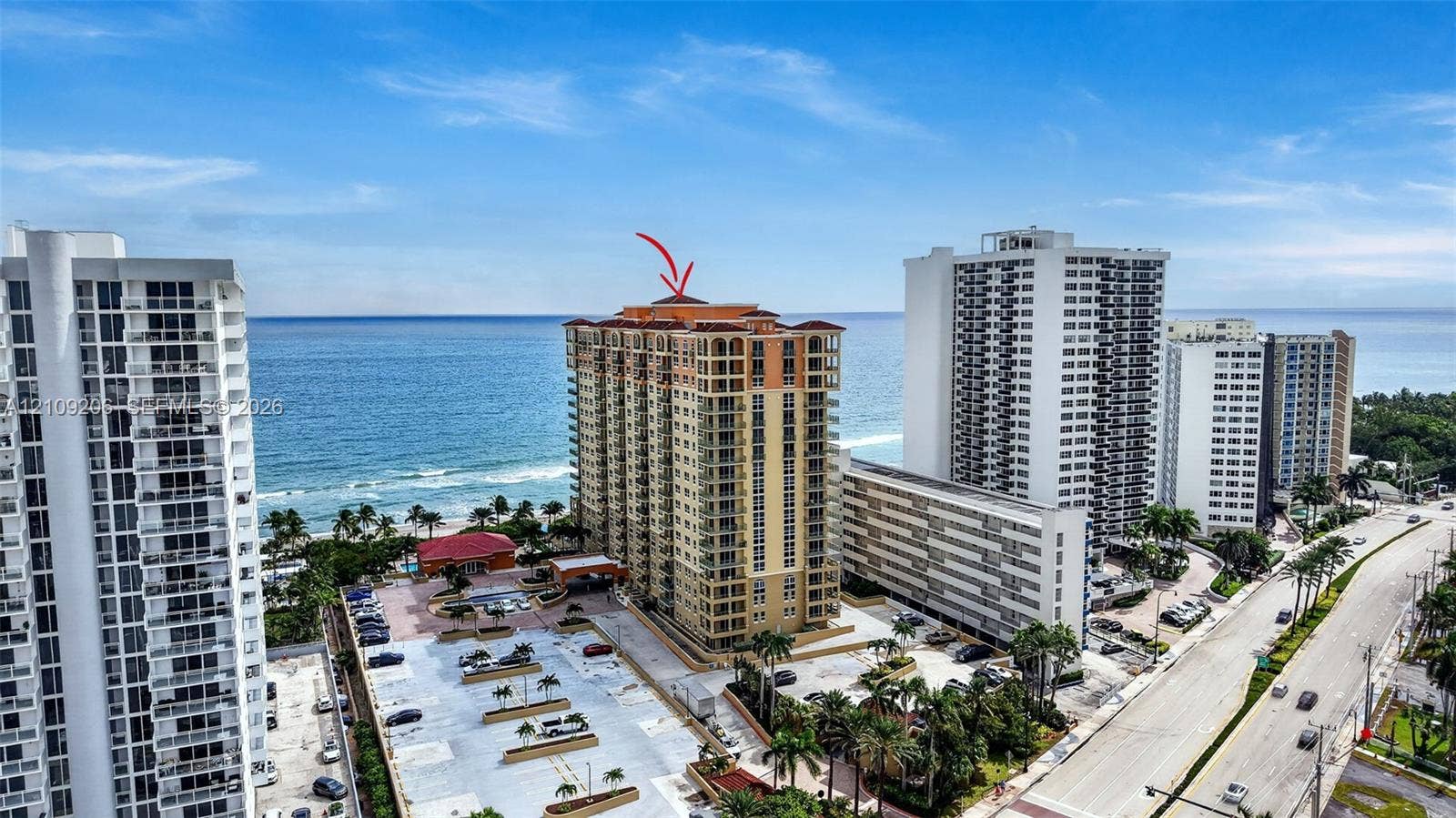 2080 S Ocean Drive, #112, Hallandale Beach, Hallandale Beach, FL 33009 High-rise building featuring a terracotta-tiled roof, glass-railed balconies, and direct proximity to the shoreline