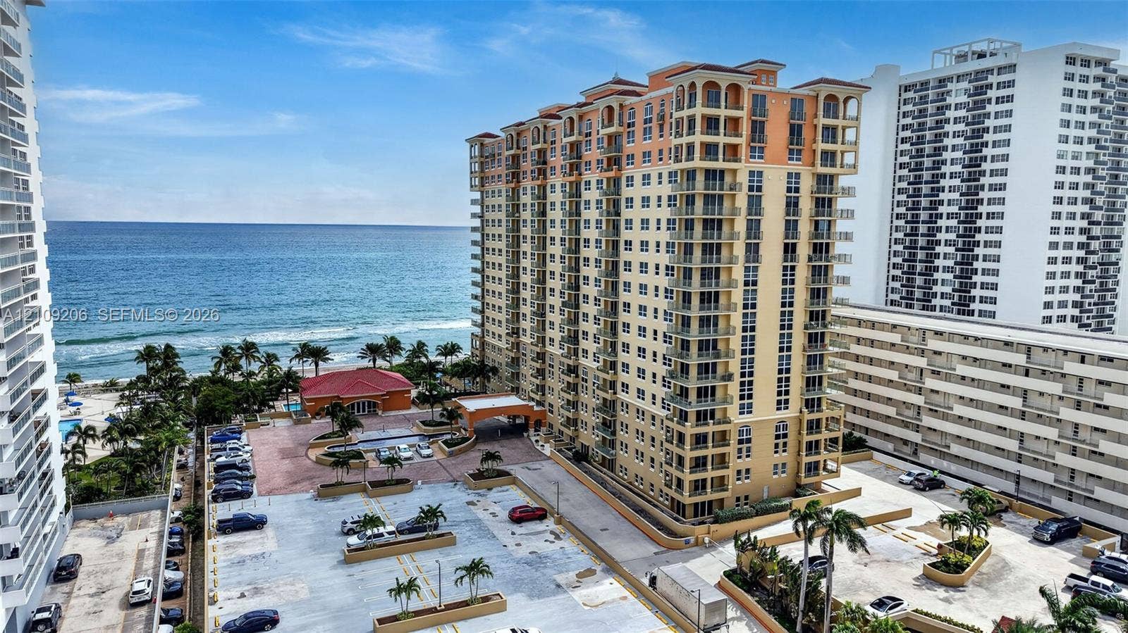 2080 S Ocean Drive, #112, Hallandale Beach, Hallandale Beach, FL 33009 High-rise coastal building featuring private balconies, arched architectural detailing, a paved motor court, and proximity to the shoreline