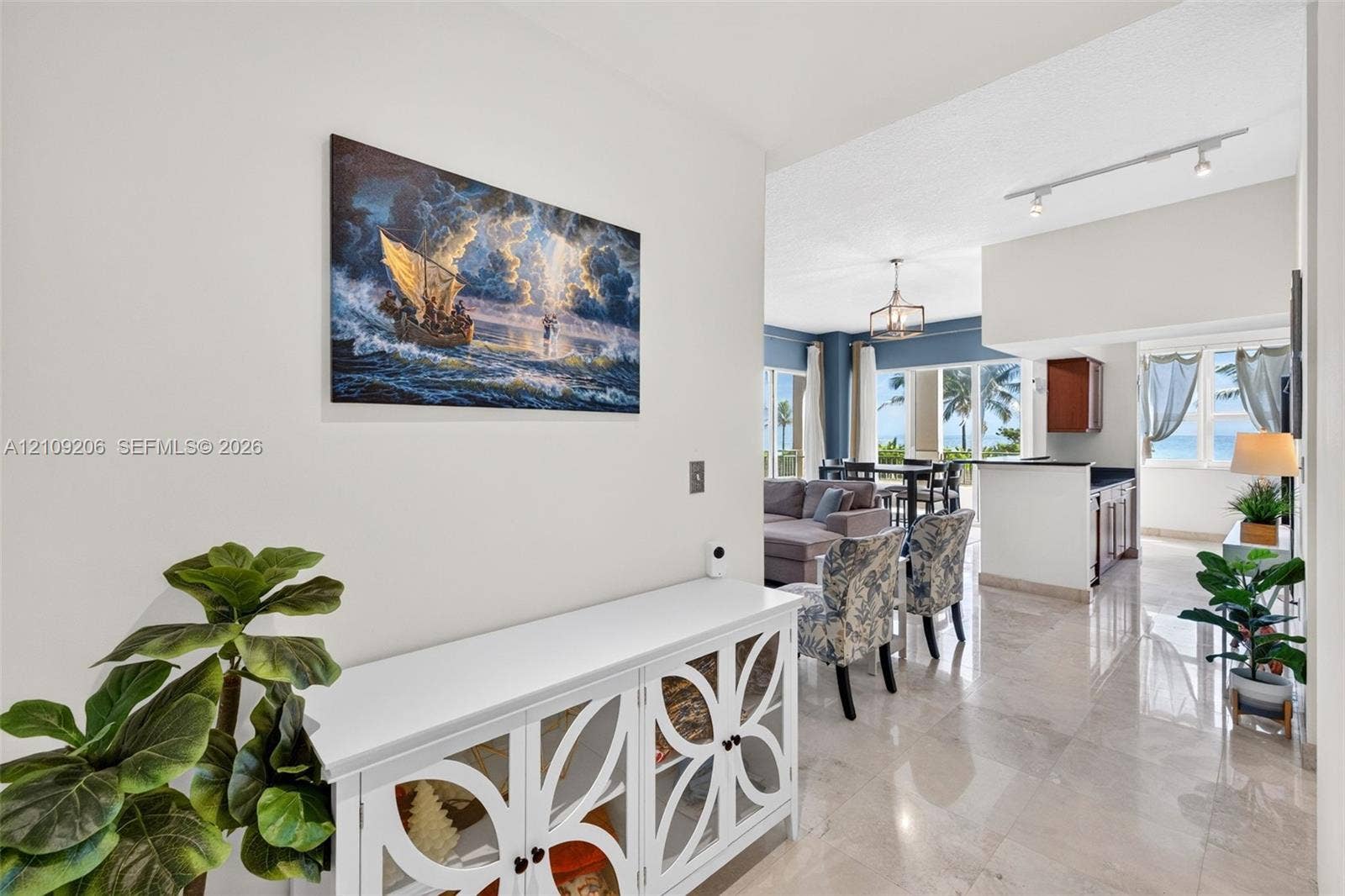 2080 S Ocean Drive, #112, Hallandale Beach, Hallandale Beach, FL 33009 Interior featuring polished stone flooring, recessed track lighting, and a multi-light chandelier