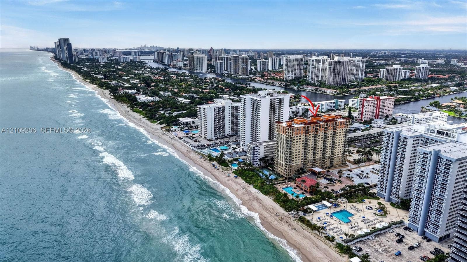 2080 S Ocean Drive, #112, Hallandale Beach, Hallandale Beach, FL 33009 Aerial perspective of high-rise building situated along the coastline featuring proximity to the ocean and paved surface parking