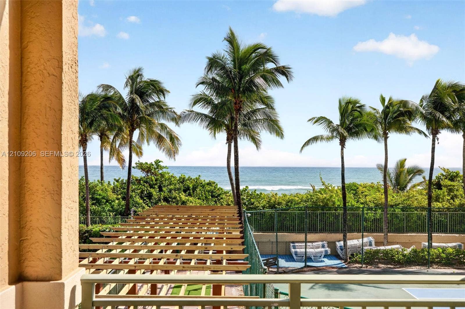 2080 S Ocean Drive, #112, Hallandale Beach, Hallandale Beach, FL 33009 Outdoor terrace featuring a natural wood pergola, metal railing, and ocean backdrop