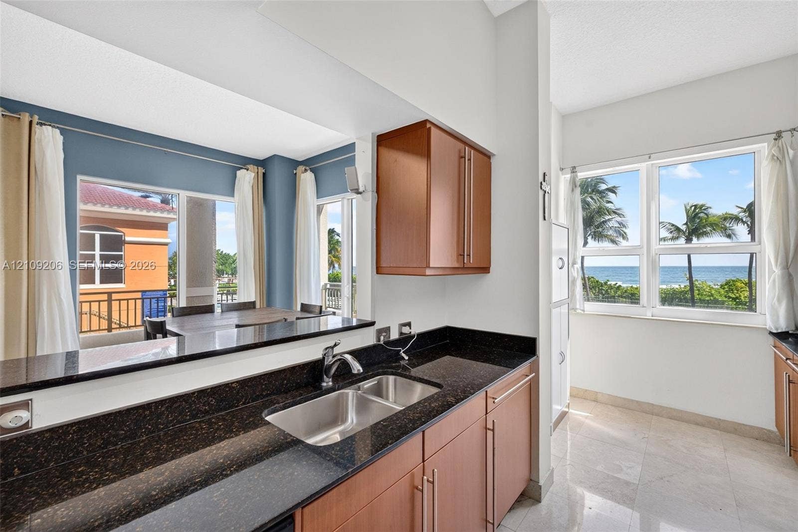 2080 S Ocean Drive, #112, Hallandale Beach, Hallandale Beach, FL 33009 Kitchen featuring dark stone countertops, wood-finish cabinetry, a stainless steel dual-basin undermount sink, and tile flooring