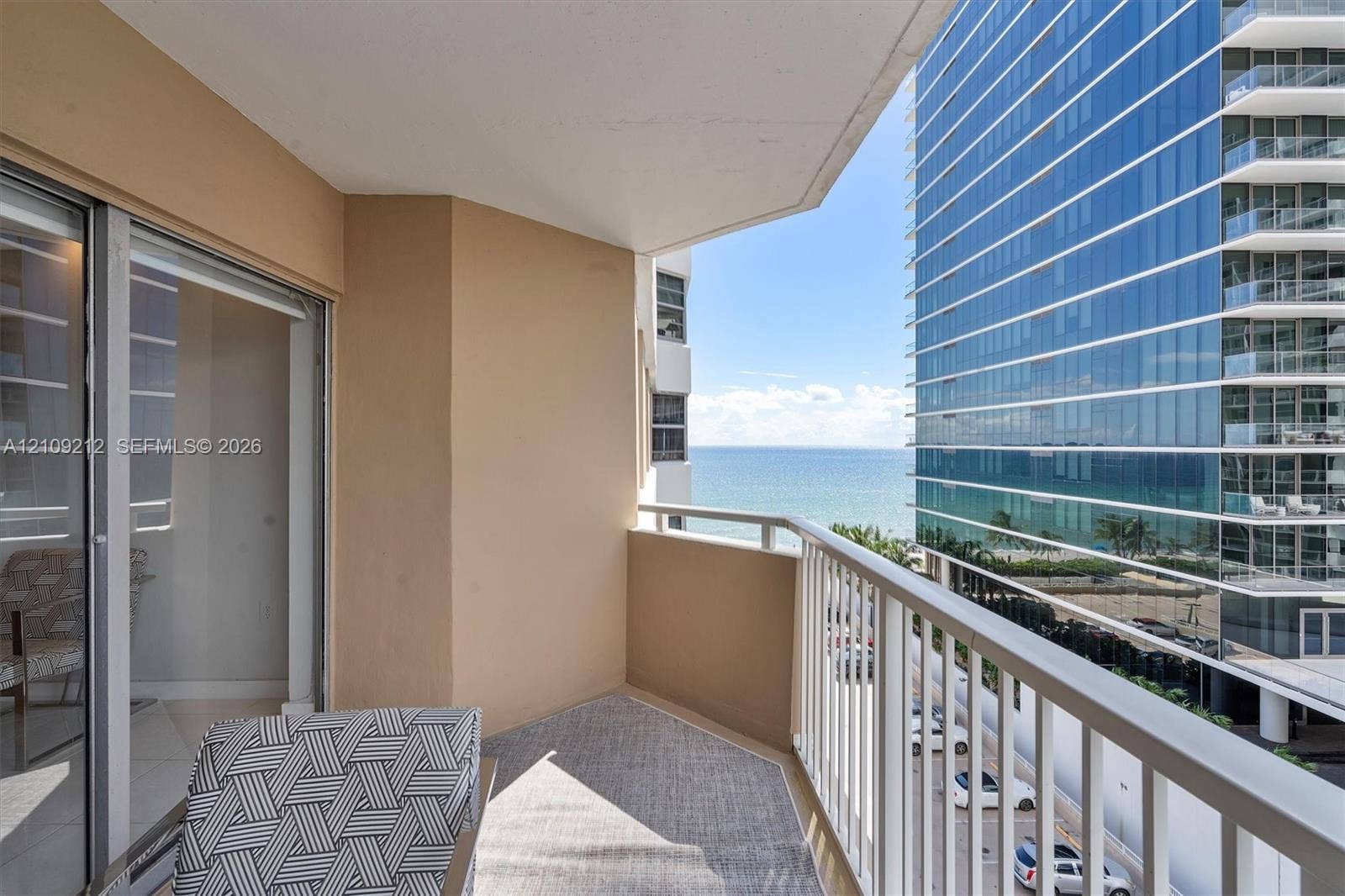 Covered balcony featuring a white metal railing and tile flooring