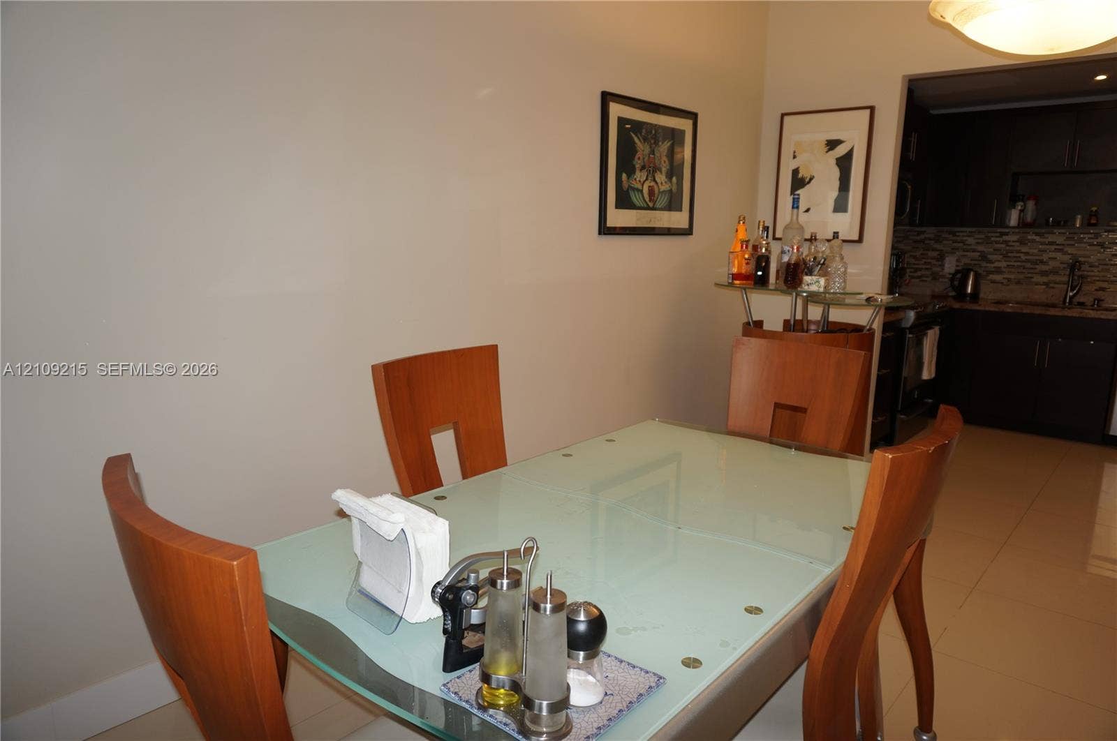 Tile flooring, recessed lighting, and kitchen cabinetry with a decorative tile backsplash