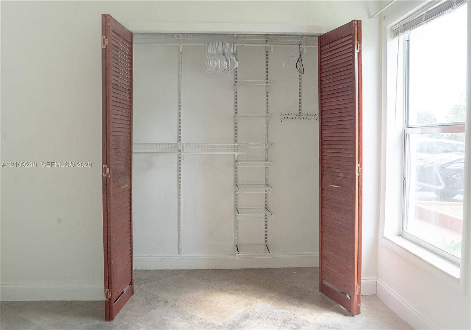 21115 SW 125th Ct Road, Miami, Miami, FL 33177 Closet featuring bi-fold louvered wood doors and a white wire shelving system