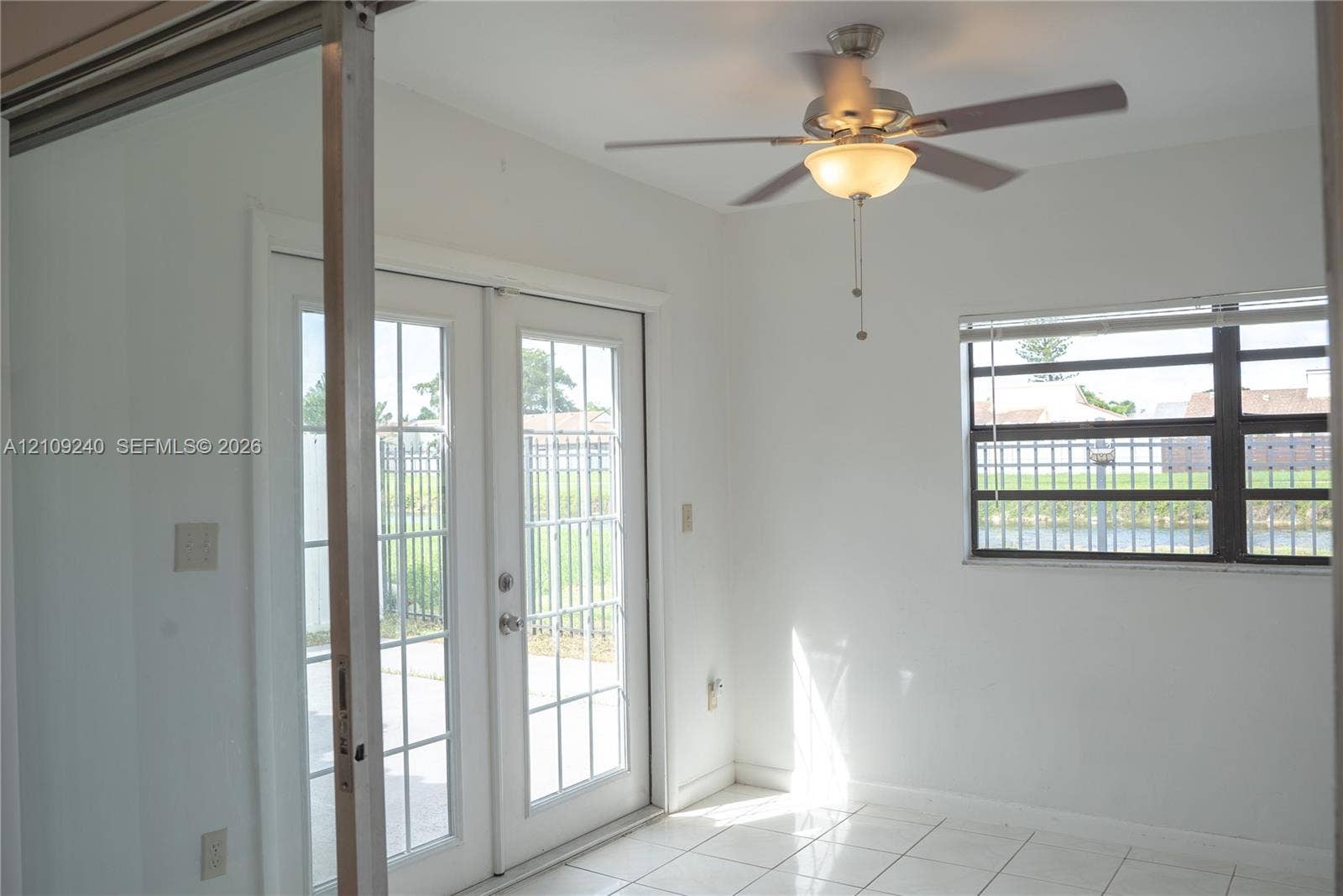 21115 SW 125th Ct Road, Miami, Miami, FL 33177 Room featuring white ceramic tile flooring, French doors with glass panes, a ceiling fan with integrated lighting, and a multi-pane window