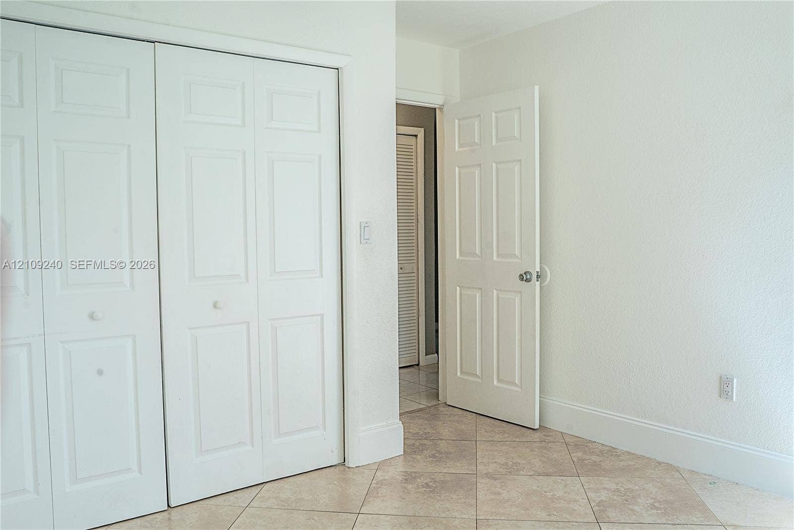 21115 SW 125th Ct Road, Miami, Miami, FL 33177 Interior room featuring ceramic tile flooring, two-panel closet doors, and six-panel interior door