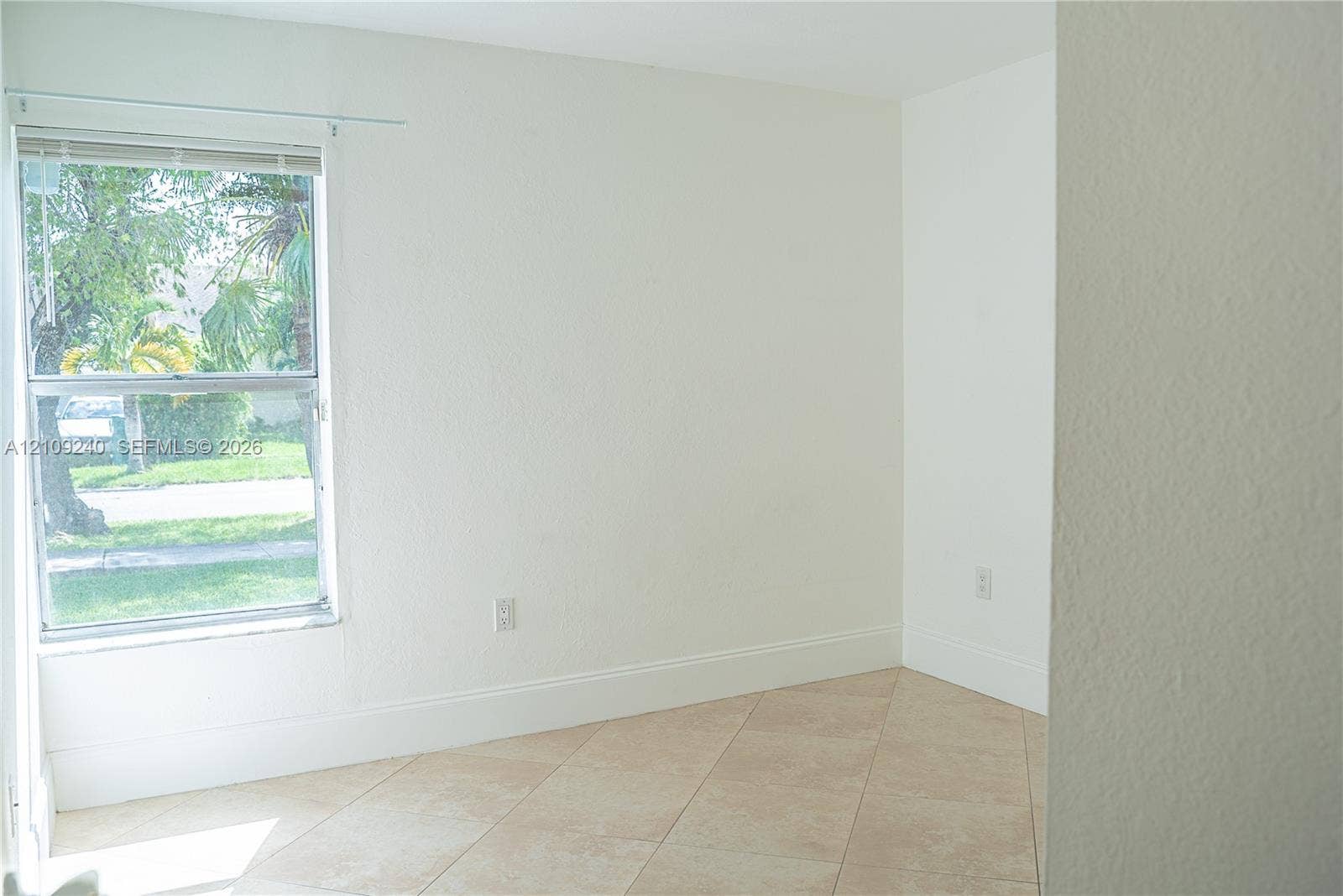 21115 SW 125th Ct Road, Miami, Miami, FL 33177 Neutral-toned wall finish, light-colored tile flooring, and single-hung window with a metal frame