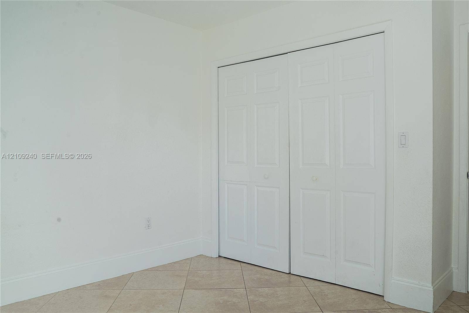 21115 SW 125th Ct Road, Miami, Miami, FL 33177 Neutral-toned interior space featuring light-colored tile flooring and dual-panel closet doors