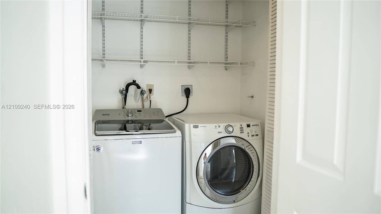 21115 SW 125th Ct Road, Miami, Miami, FL 33177 Laundry closet featuring tiered wire shelving and louvered folding doors