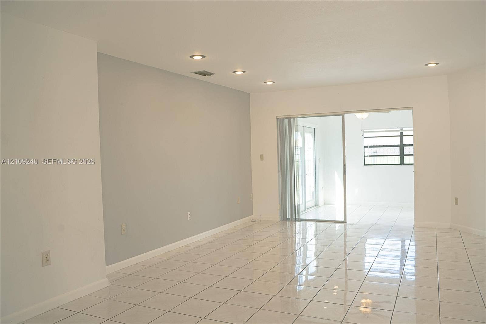 21115 SW 125th Ct Road, Miami, Miami, FL 33177 Interior space featuring neutral wall tones, polished tile flooring, recessed ceiling lighting, and a glass sliding door