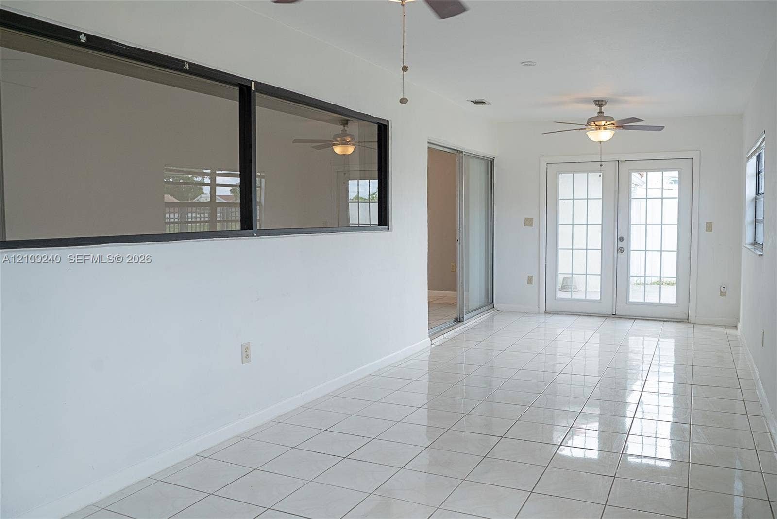 21115 SW 125th Ct Road, Miami, Miami, FL 33177 Ceramic tile flooring, white-framed French doors with glass panes, sliding glass door, and dual ceiling fans