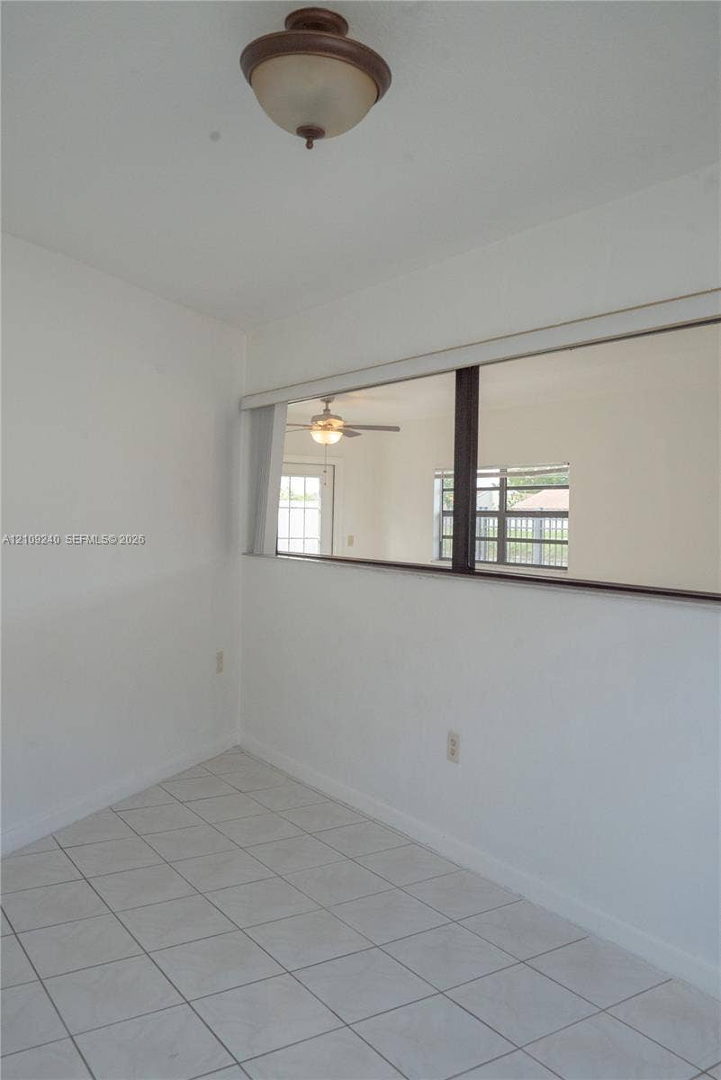 21115 SW 125th Ct Road, Miami, Miami, FL 33177 White ceramic tile flooring, semi-flush mount dome ceiling fixture, and interior rectangular wall cutout