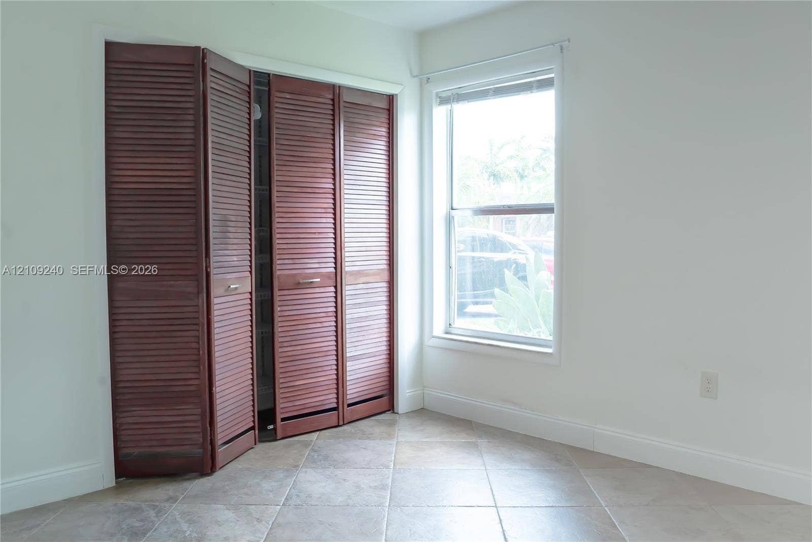 21115 SW 125th Ct Road, Miami, Miami, FL 33177 Stained wood louvered bi-fold closet doors and neutral-tone tile flooring