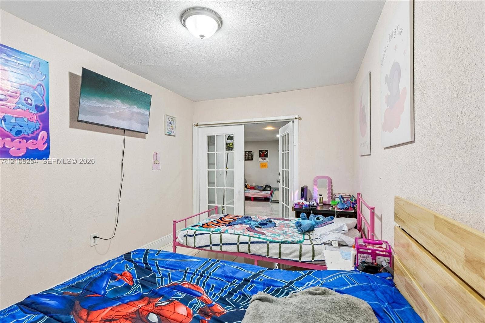 21342 NW 40th Cir Court, Miami Gardens, FL 33055 Interior space featuring a dome-style ceiling light fixture and white French doors with glass panes