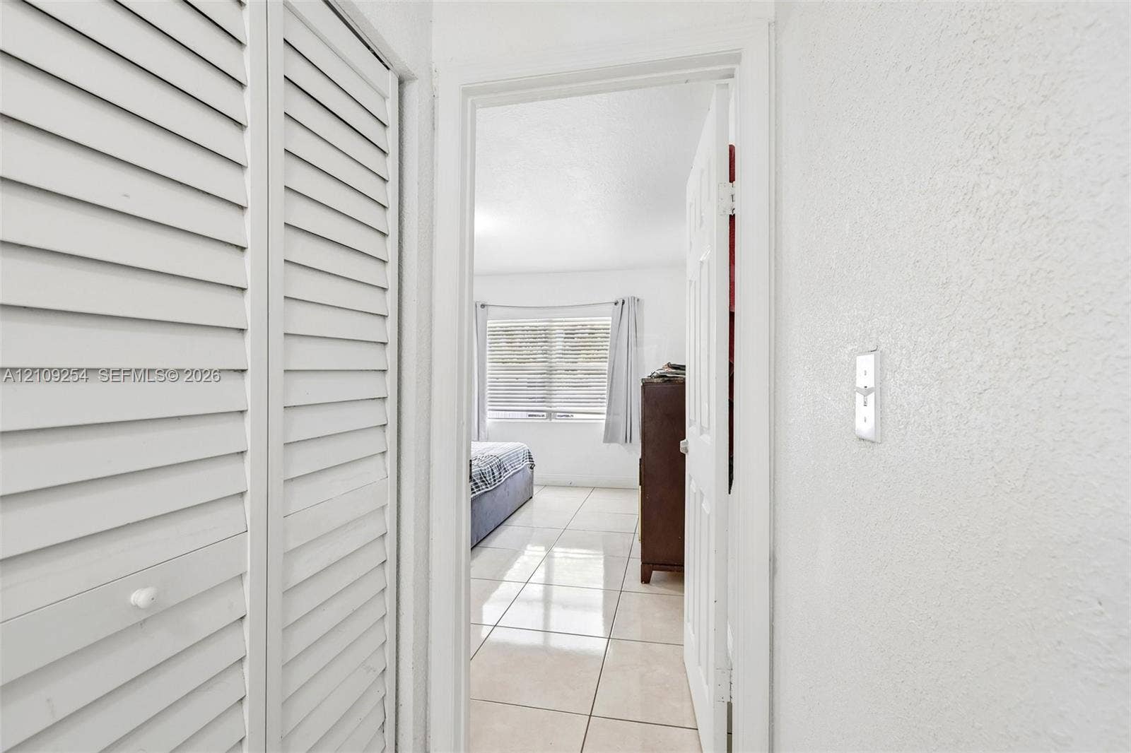 21342 NW 40th Cir Court, Miami Gardens, FL 33055 White louvered bi-fold closet doors and neutral large-format tile flooring