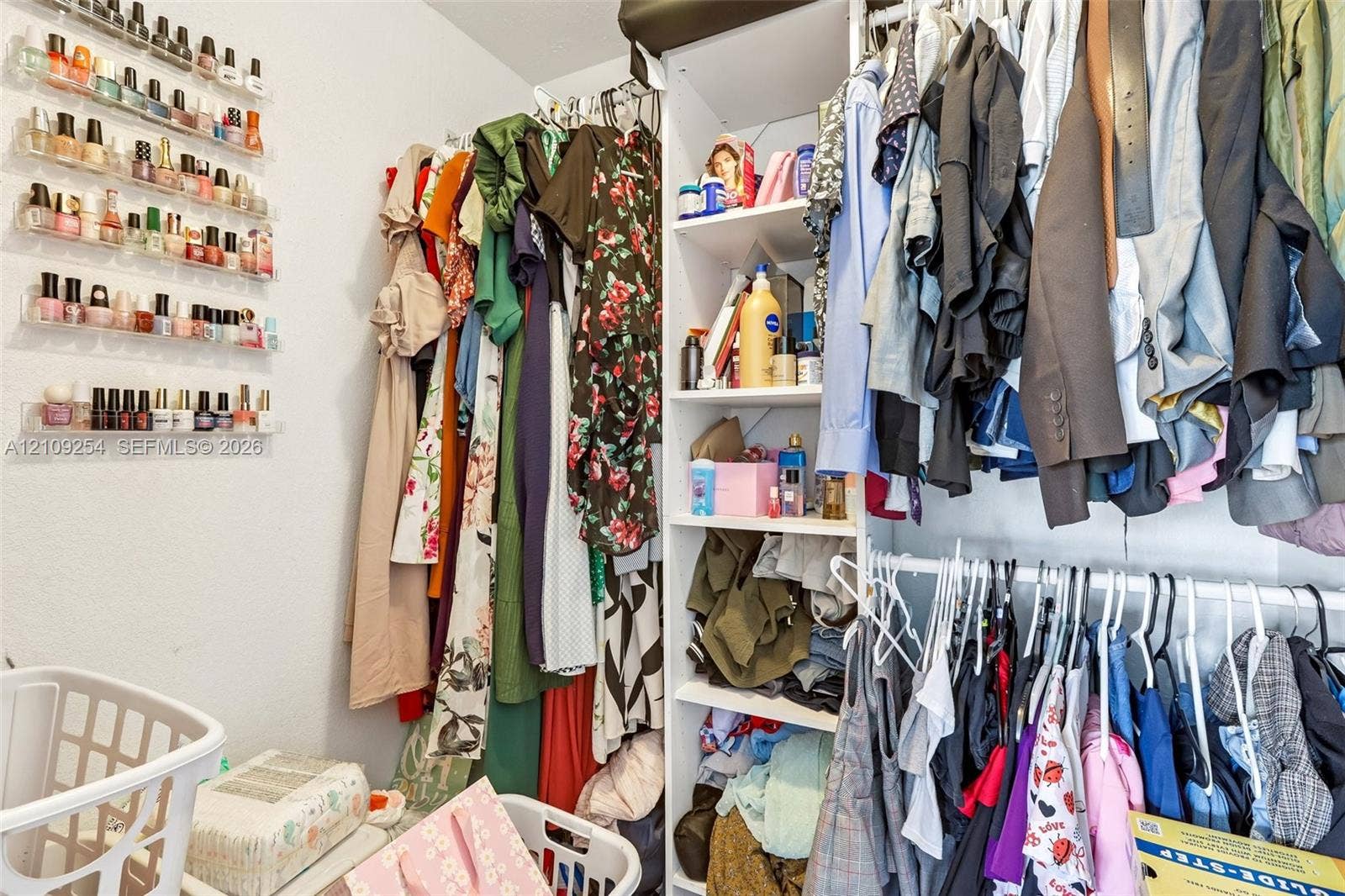21342 NW 40th Cir Court, Miami Gardens, FL 33055 Custom-built closet system featuring vertical shelving and integrated hanging rods, complemented by wall-mounted tiered storage racks