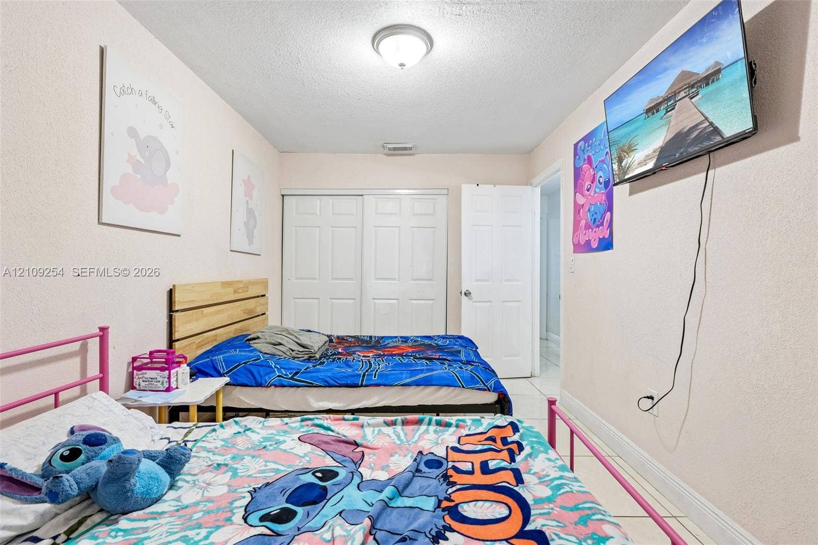 21342 NW 40th Cir Court, Miami Gardens, FL 33055 Room featuring light-toned neutral walls, white sliding-panel closet doors, and tile flooring