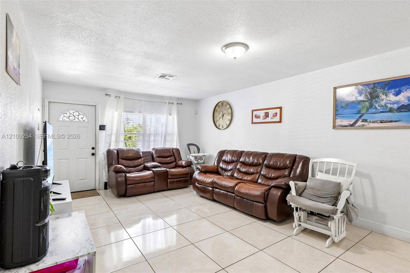21342 NW 40th Cir Court, Miami Gardens, FL 33055 Neutral-toned tile flooring, white wall finish, and an exterior entry door featuring decorative glass inlay