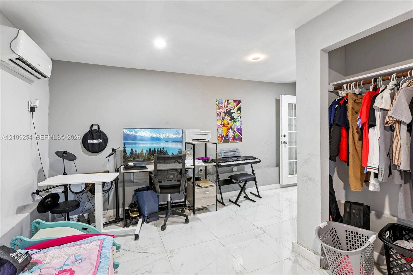 21342 NW 40th Cir Court, Miami Gardens, FL 33055 Interior room featuring polished tile flooring, wall-mounted climate control unit, recessed lighting, and a reach-in closet with built-in shelving