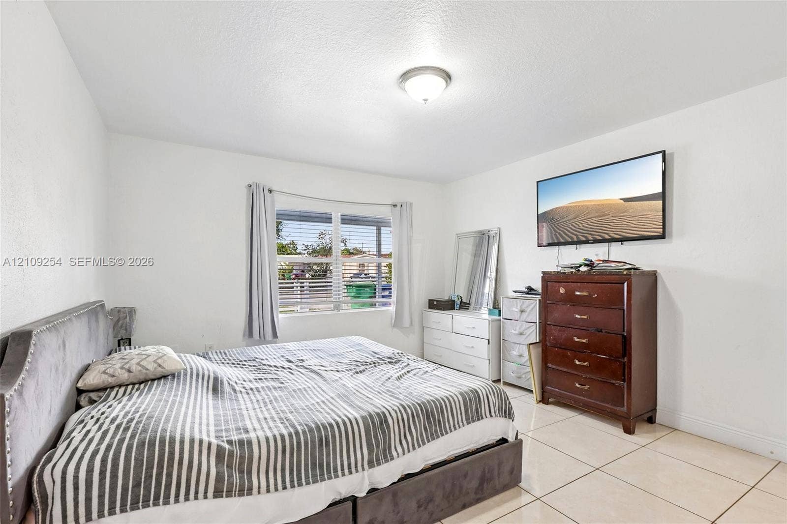 21342 NW 40th Cir Court, Miami Gardens, FL 33055 Neutral-toned tile flooring, flush-mount ceiling light fixture, and dual-pane window