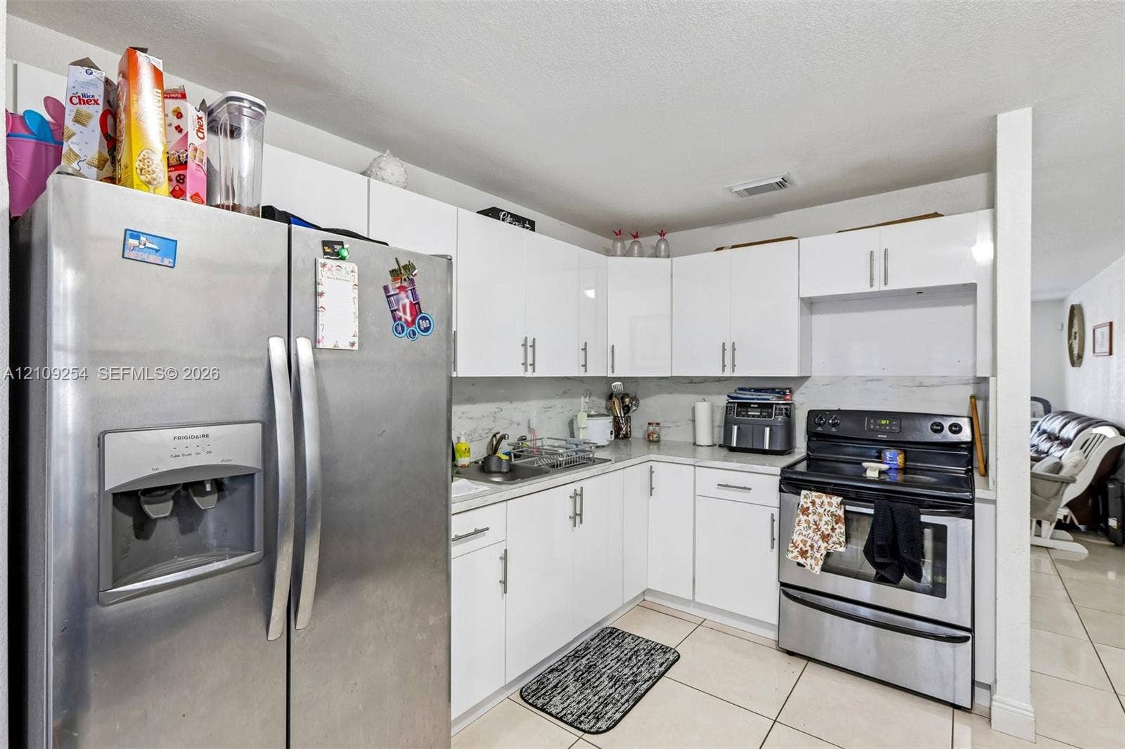 21342 NW 40th Cir Court, Miami Gardens, FL 33055 Kitchen featuring white cabinetry, stainless steel appliances, and tile flooring