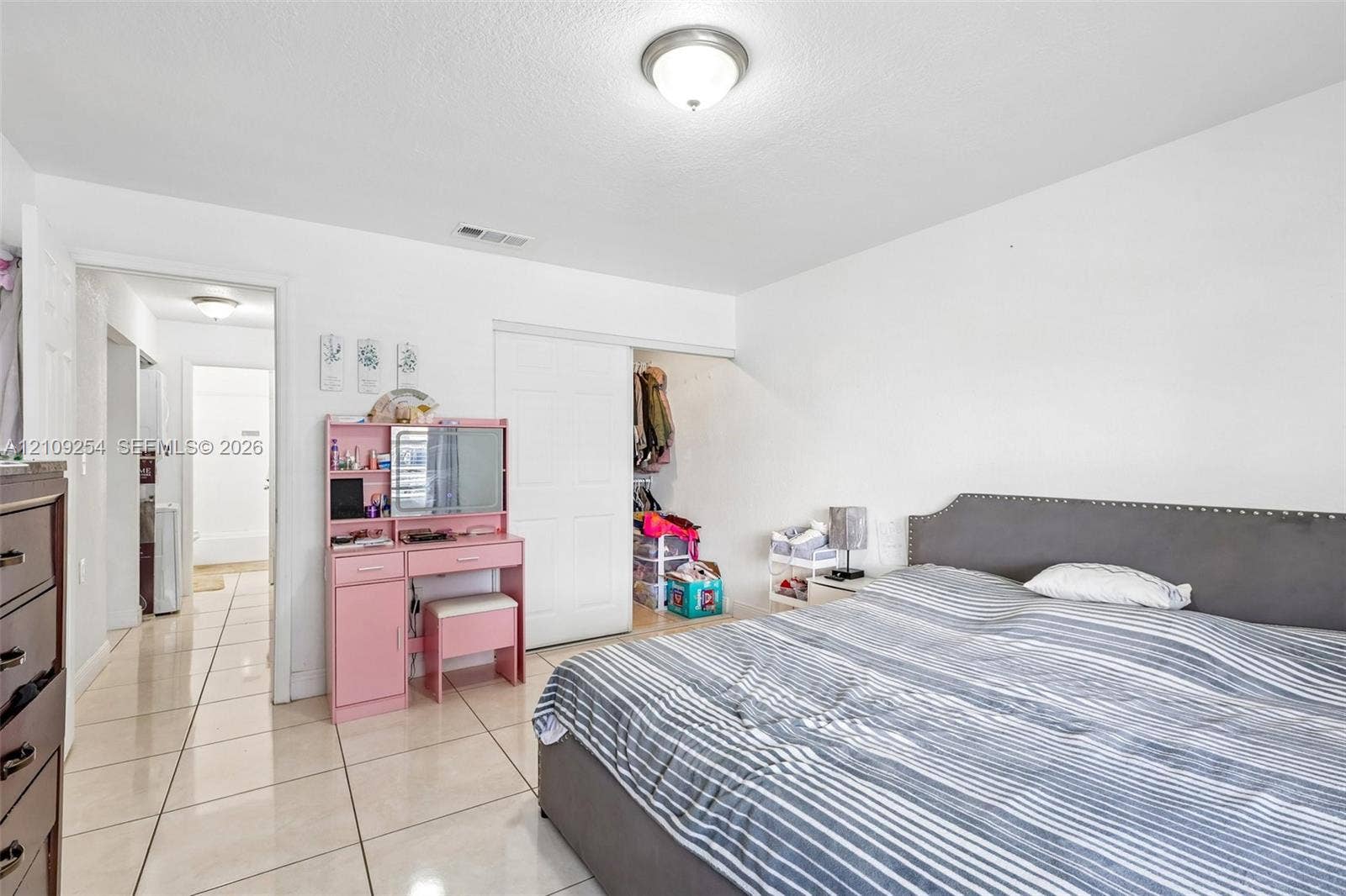 21342 NW 40th Cir Court, Miami Gardens, FL 33055 Neutral-toned ceramic tile flooring, semi-flush mount ceiling lighting, and sliding closet doors