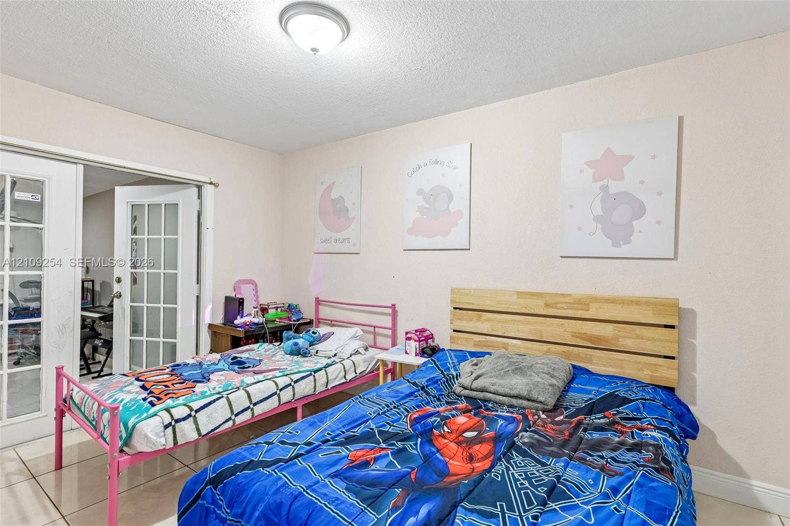 21342 NW 40th Cir Court, Miami Gardens, FL 33055 Room featuring ceramic tile flooring, neutral walls, and white French doors with glass panes