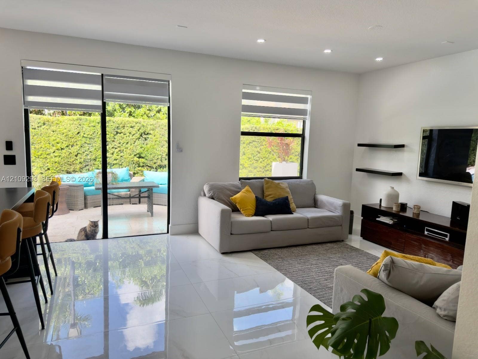 8880 NW 115th Court, Doral, FL 33178 High-gloss tile flooring, floor-to-ceiling sliding glass doors, recessed lighting, and built-in wall-mounted shelving