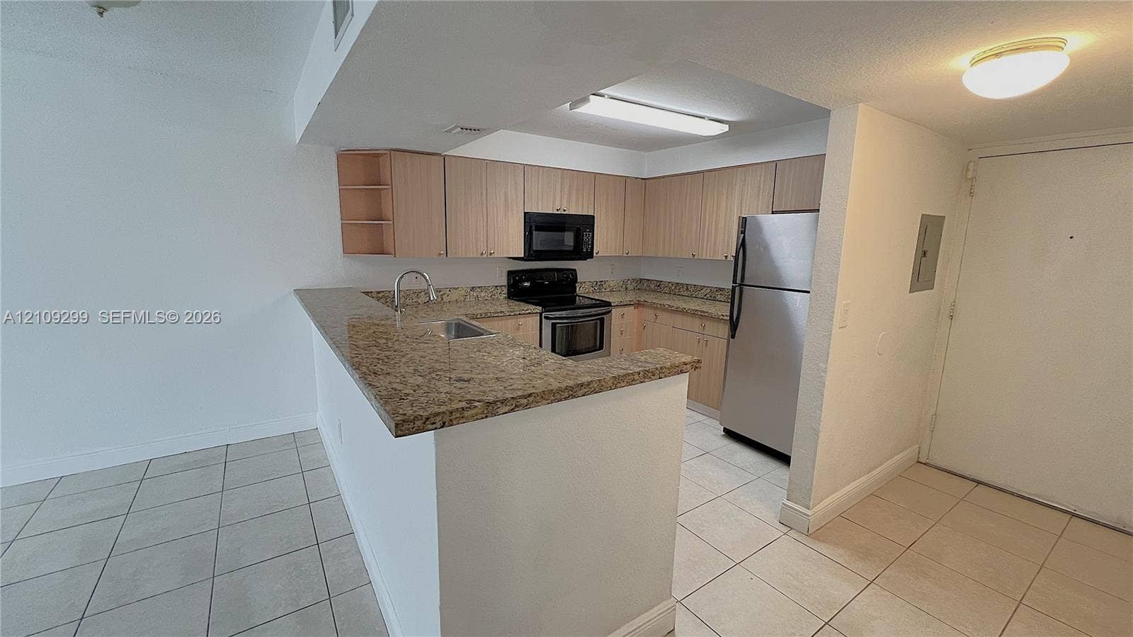 4810 NW 79 Avenue, #107, Doral, Doral, FL 33166 Kitchen featuring light-finish cabinetry, stone-surface countertops, tile flooring, and stainless steel appliances