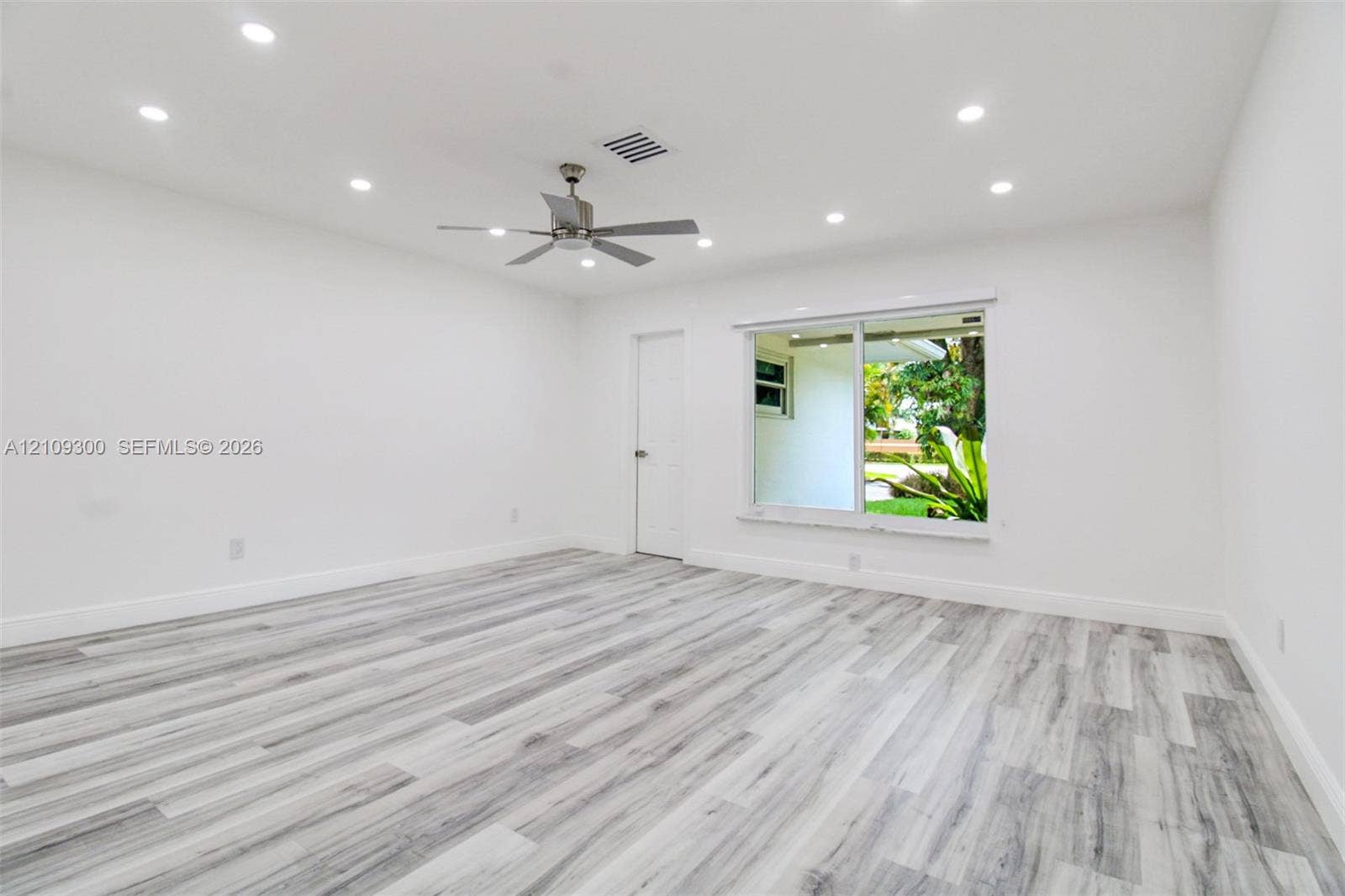 Interior space featuring wood-finish flooring, recessed lighting, and a metal-finish ceiling fan