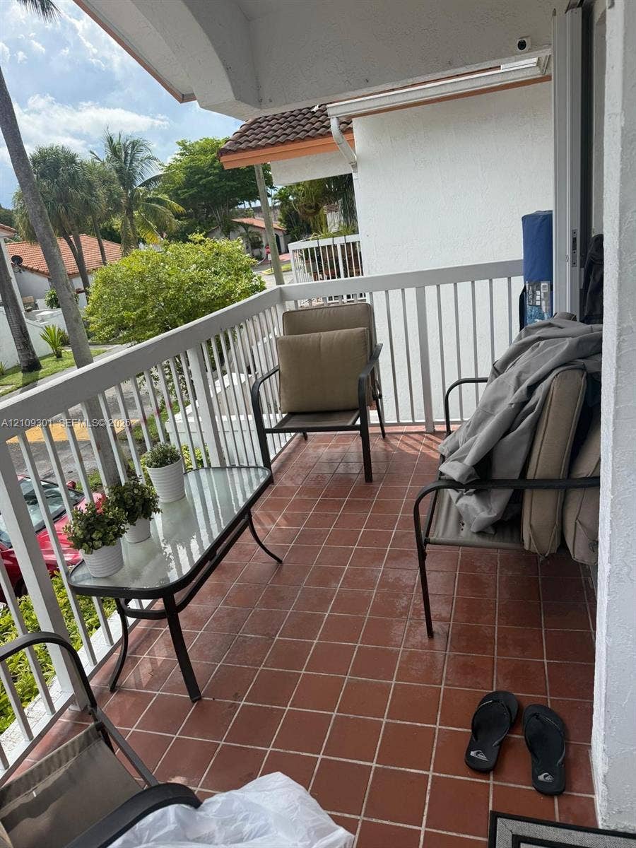 7680 SW 153rd Court, #204, Miami, Miami, FL 33193 Covered balcony featuring terracotta-style tile flooring and white vertical railings