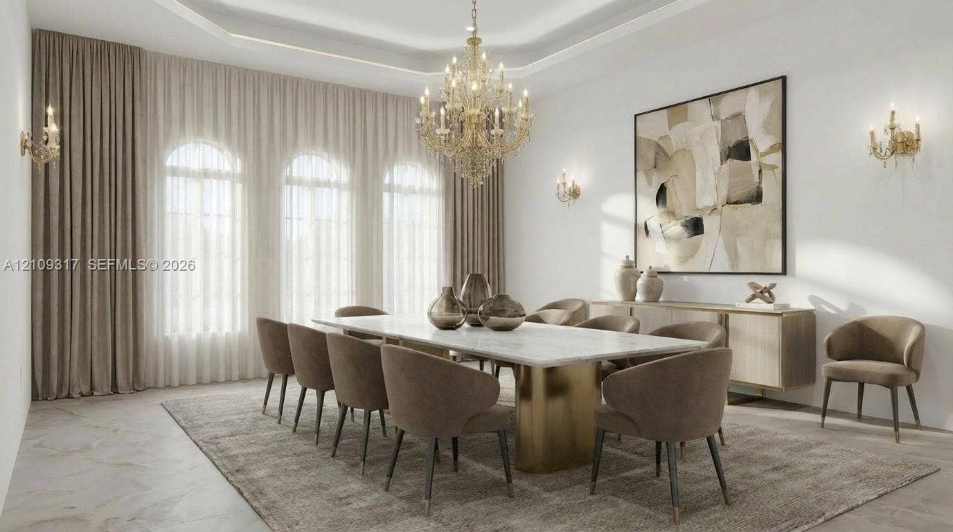 Arched windows with floor-to-ceiling drapery, tiered tray ceiling, ornate crystal chandelier, and wall-mounted sconces