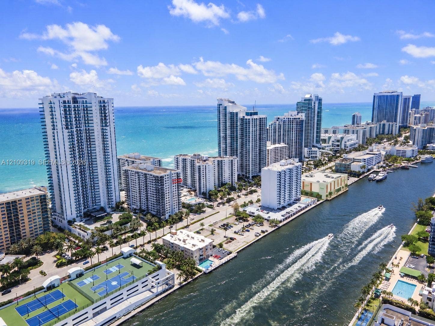 2751 S Ocean Drive, #1608N, Hollywood, FL 33019 Aerial perspective of coastal high-rise development featuring waterfront proximity, hardscaped recreation courts, and open water access