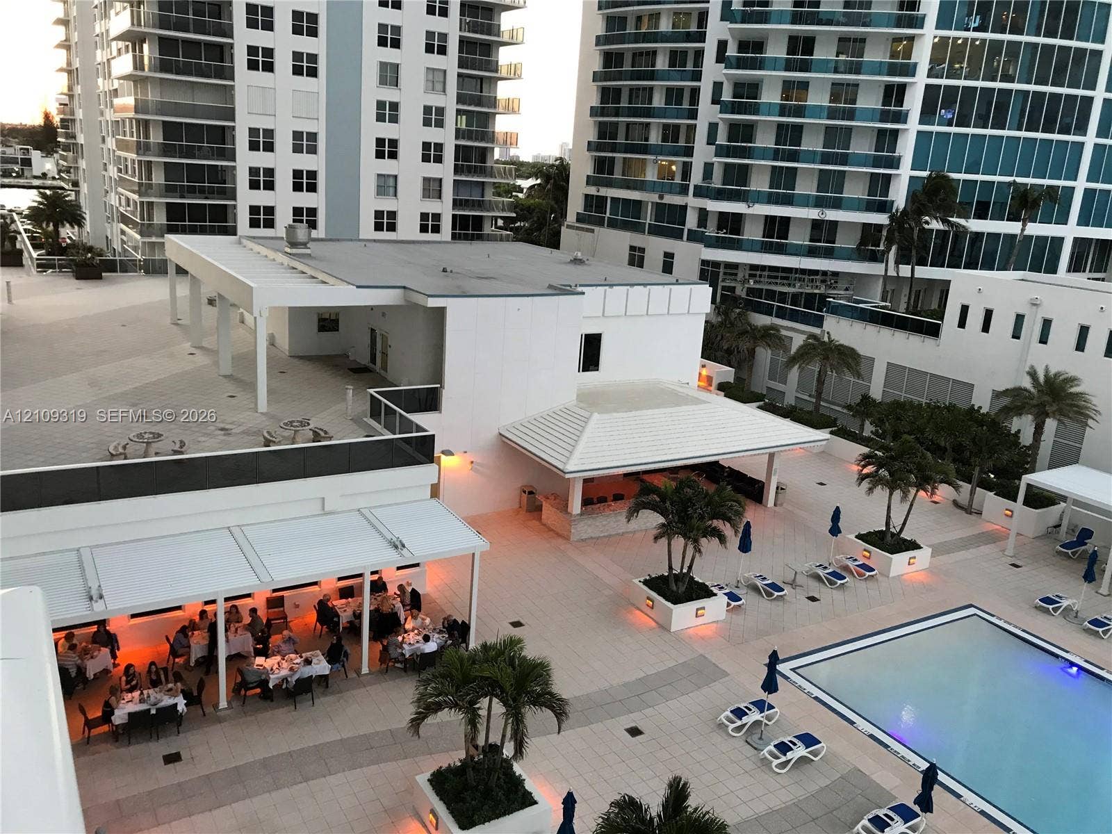2751 S Ocean Drive, #1608N, Hollywood, FL 33019 Outdoor terrace featuring a swimming pool, multiple covered dining pavilions, built-in bar area, and tiled hardscaping with integrated landscaping